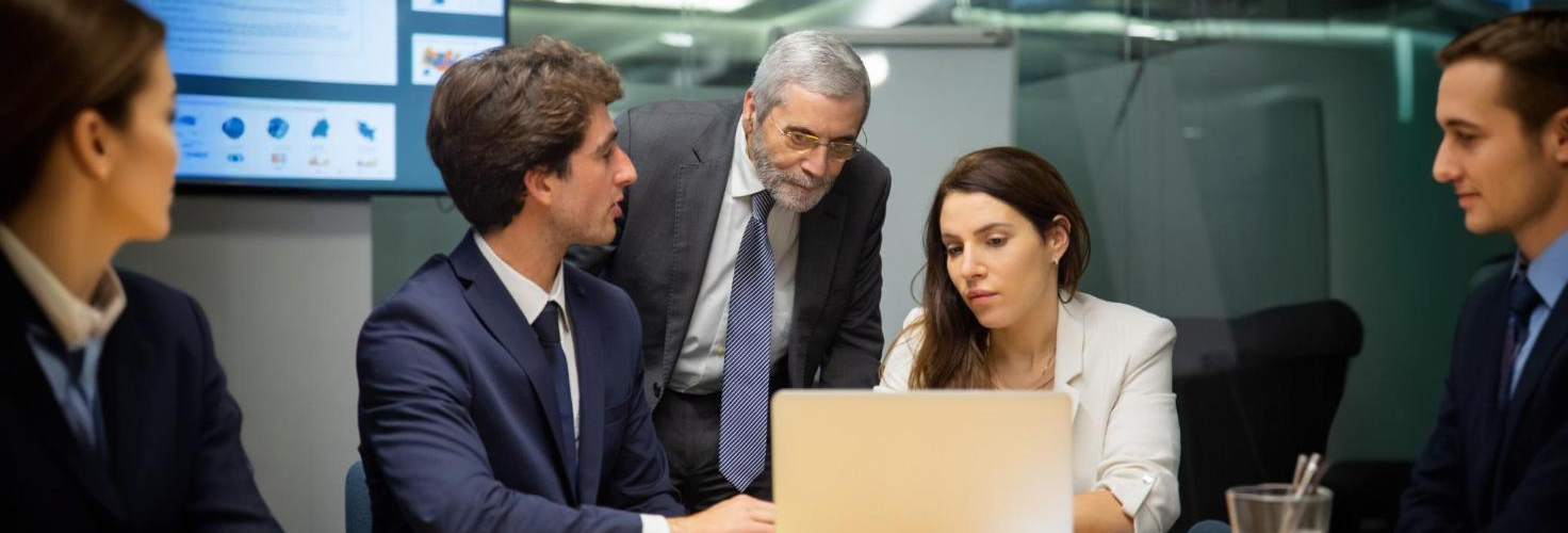 5 people seen at a discussion at a board room